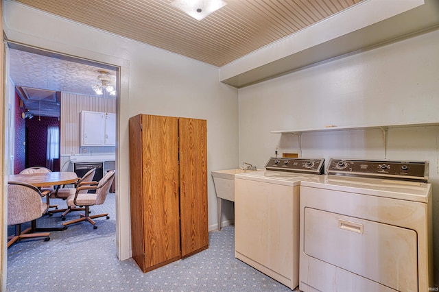 laundry room with sink, wood ceiling, and washer and dryer