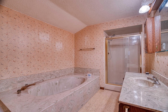 bathroom with a textured ceiling, vanity, independent shower and bath, and vaulted ceiling