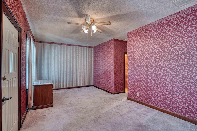 bonus room with ceiling fan, a textured ceiling, and light carpet