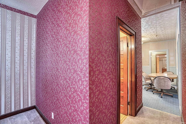 hall featuring light colored carpet and crown molding