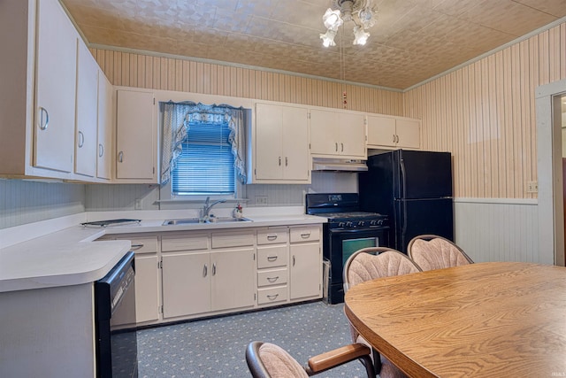 kitchen featuring sink, white cabinets, black appliances, and ornamental molding