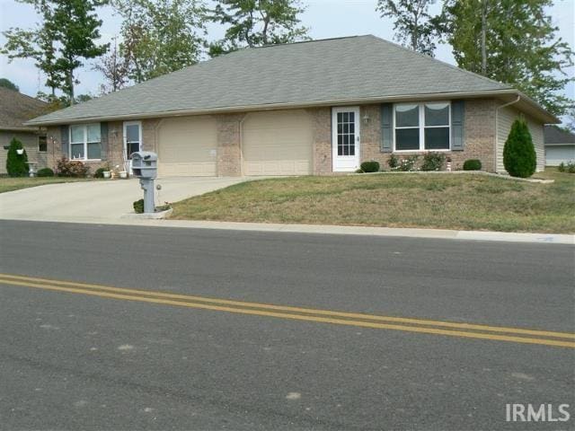 single story home featuring a front yard and a garage