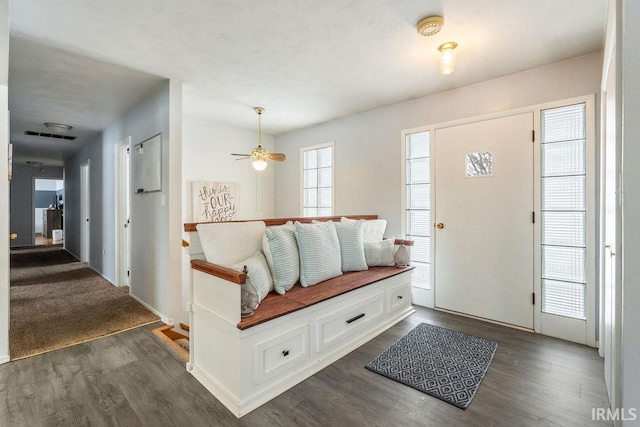 foyer entrance featuring ceiling fan and dark wood-type flooring