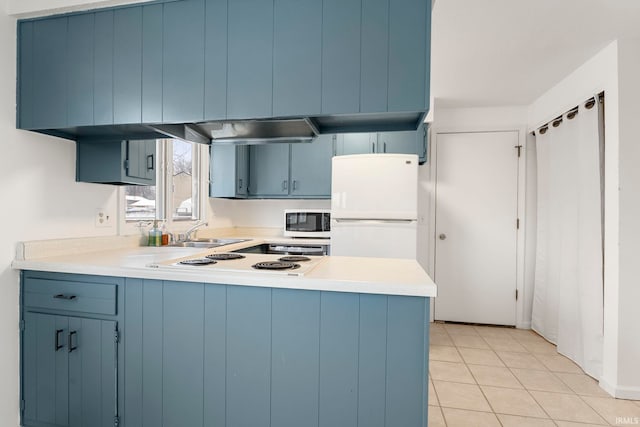 kitchen with blue cabinetry, kitchen peninsula, light tile patterned floors, and white appliances