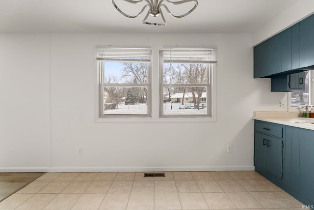 unfurnished dining area with a notable chandelier