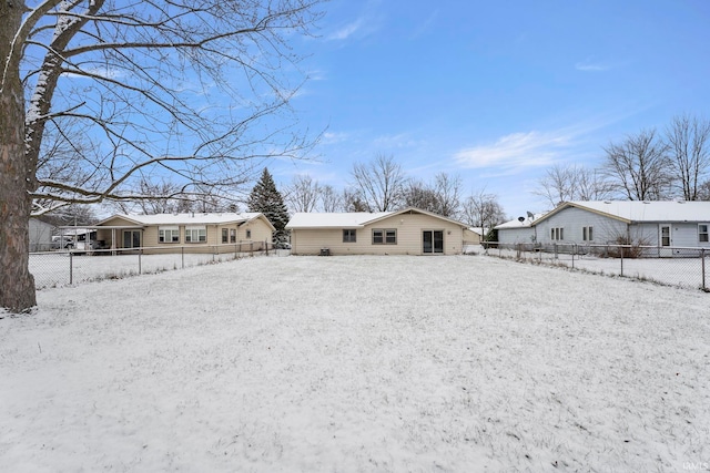 view of snow covered rear of property