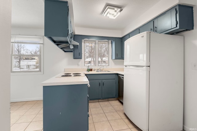 kitchen with light tile patterned floors, blue cabinets, sink, and white appliances