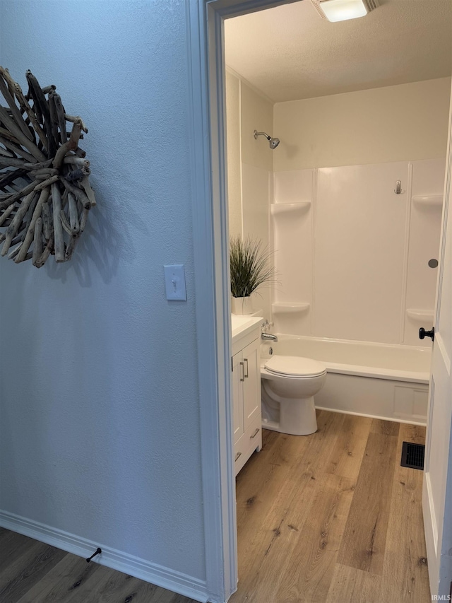 full bathroom featuring toilet, vanity, shower / bath combination, and hardwood / wood-style floors