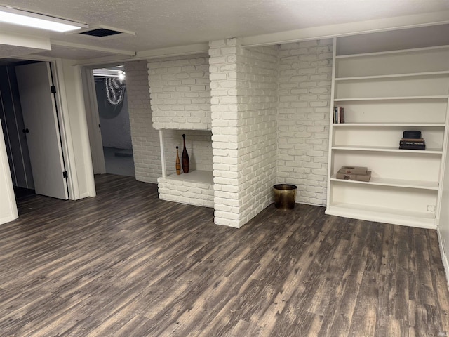 unfurnished living room featuring a textured ceiling and dark wood-type flooring