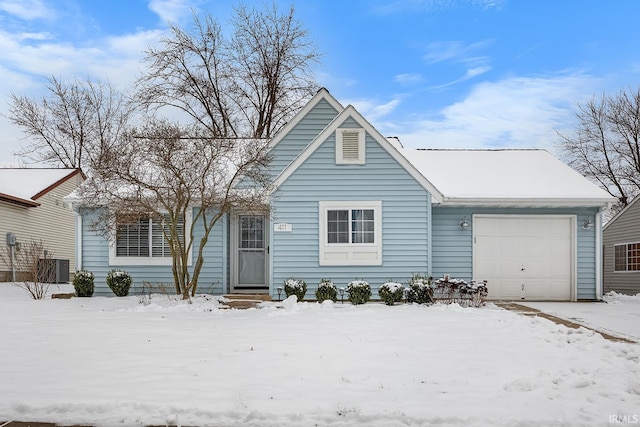 view of front of property featuring a garage and central AC