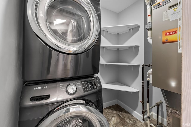 clothes washing area featuring stacked washing maching and dryer