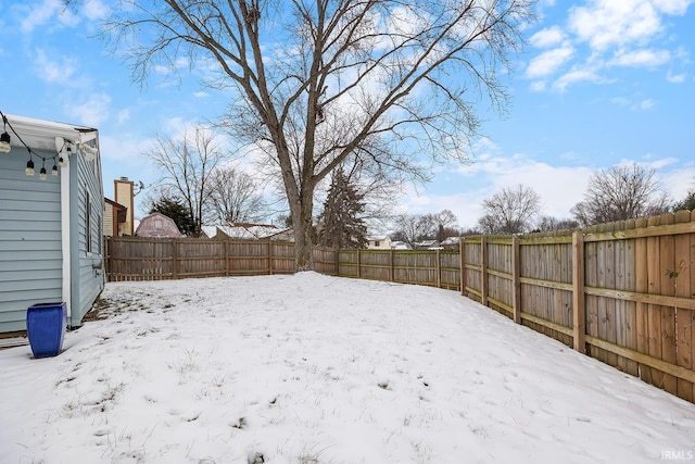 view of yard layered in snow