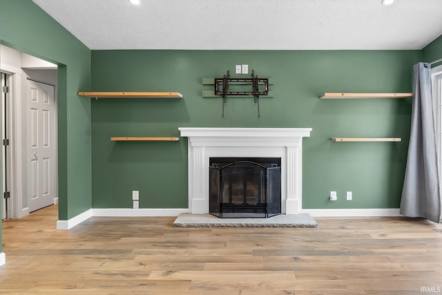 details with hardwood / wood-style flooring and a textured ceiling