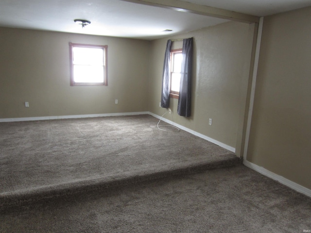 unfurnished room featuring carpet flooring and a healthy amount of sunlight