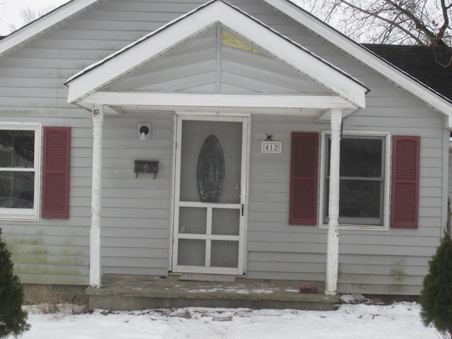 view of snow covered property entrance