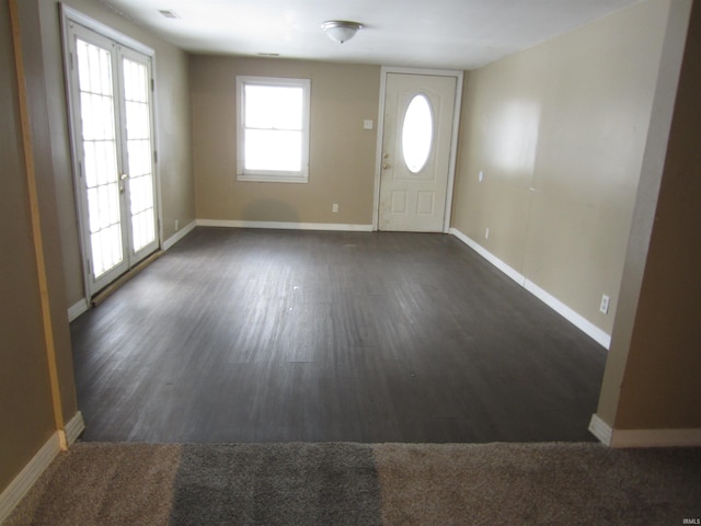 foyer entrance featuring dark hardwood / wood-style flooring and french doors