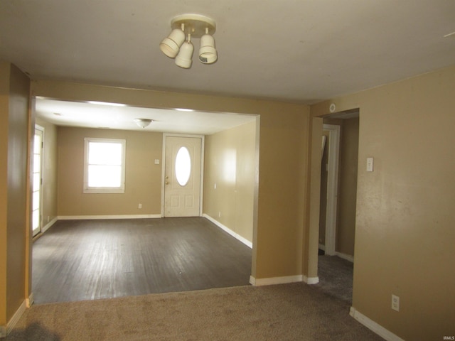 entryway with dark colored carpet