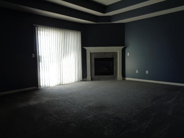 unfurnished living room featuring a tiled fireplace