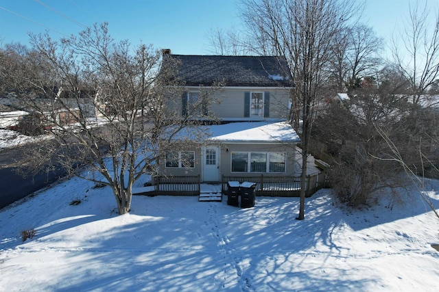 view of snow covered back of property