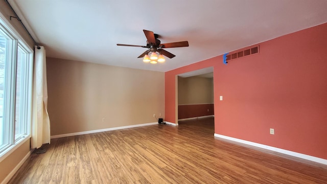 spare room with ceiling fan and light wood-type flooring