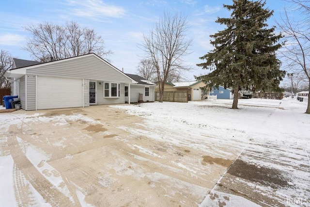 view of snowy exterior featuring a garage