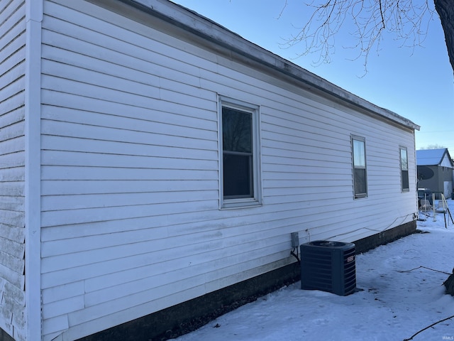 view of snowy exterior featuring cooling unit