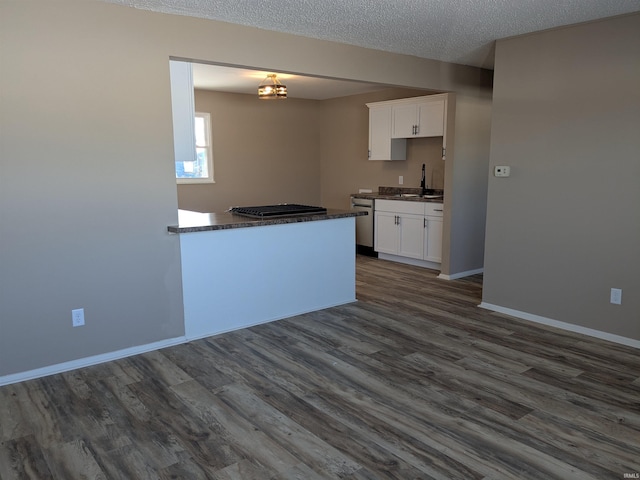 kitchen featuring dark hardwood / wood-style floors, sink, white cabinets, and dishwasher