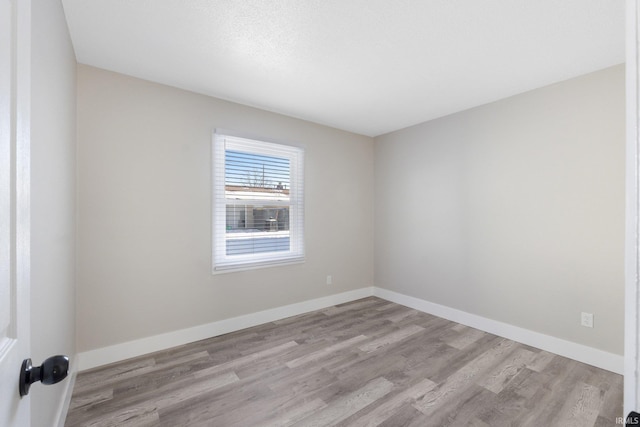 spare room featuring light hardwood / wood-style flooring