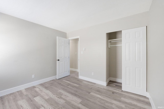 unfurnished bedroom featuring a closet and light hardwood / wood-style flooring