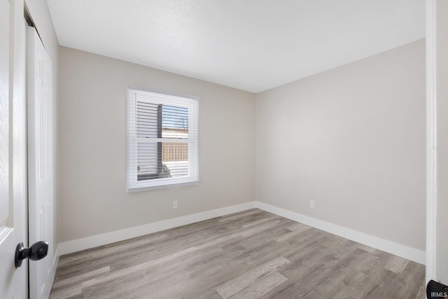 spare room with light hardwood / wood-style floors