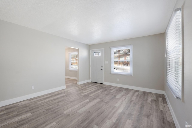 foyer featuring a textured ceiling and light hardwood / wood-style flooring