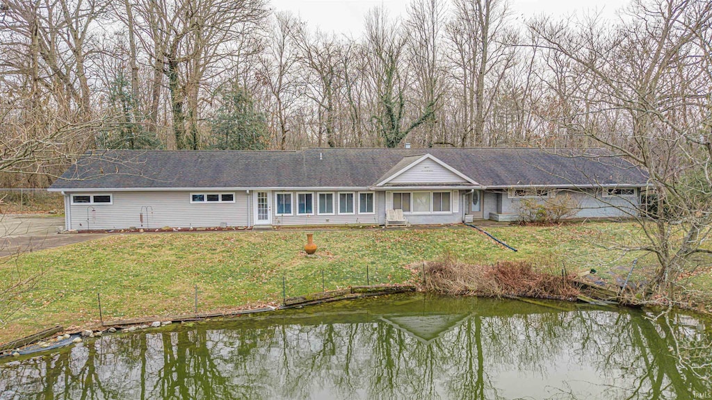 exterior space featuring a water view and a lawn