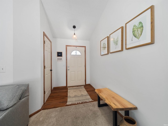 carpeted entrance foyer with lofted ceiling