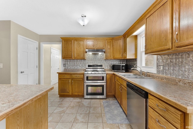 kitchen featuring sink, backsplash, appliances with stainless steel finishes, and light tile patterned flooring