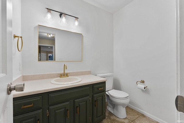 bathroom featuring toilet, vanity, and tile patterned flooring