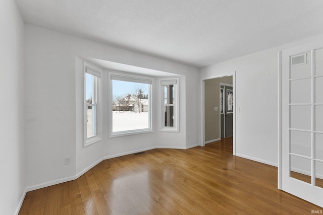 spare room with hardwood / wood-style flooring