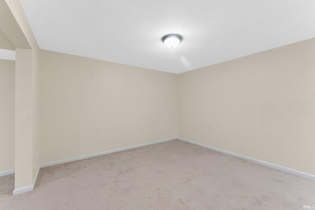 carpeted empty room with a textured ceiling