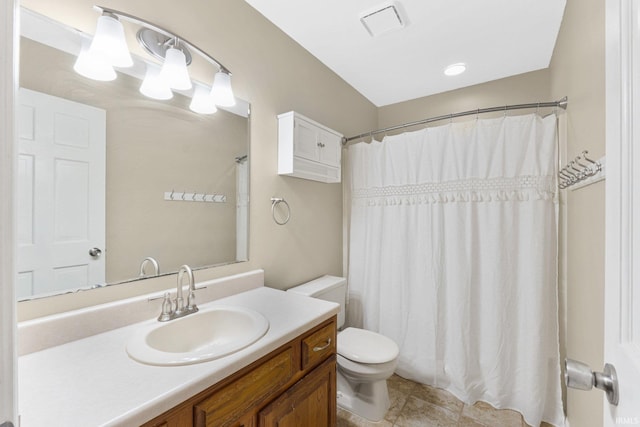 bathroom featuring toilet, vanity, a shower with curtain, and tile patterned floors