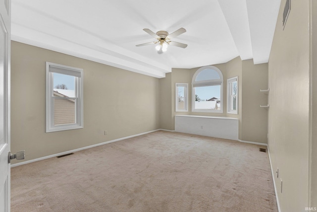 empty room featuring ceiling fan and light colored carpet