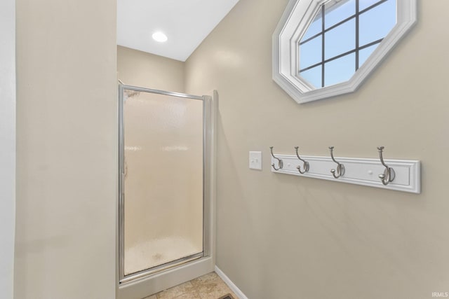 bathroom featuring tile patterned floors and a shower with door