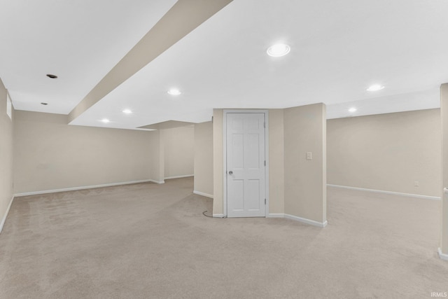 basement featuring light carpet