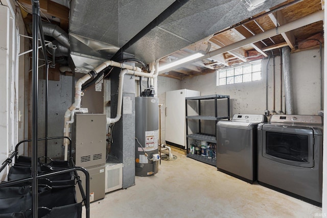 basement featuring separate washer and dryer, heating unit, and water heater