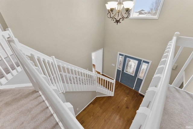 entrance foyer with an inviting chandelier, a high ceiling, and hardwood / wood-style flooring