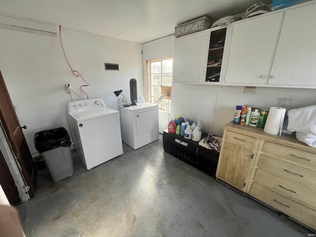 laundry area with washer and dryer and cabinets