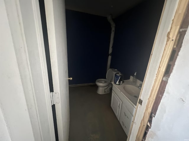 bathroom featuring toilet and vanity