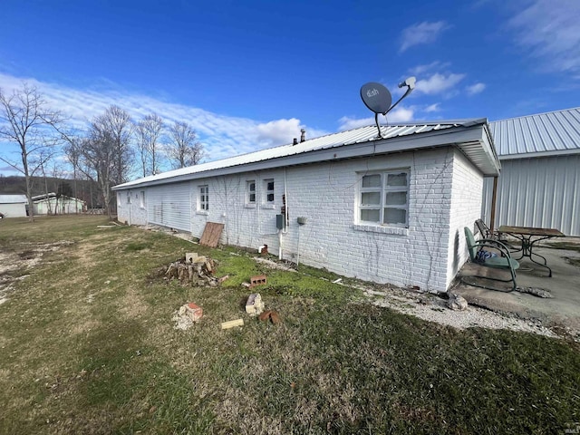 rear view of property featuring a yard