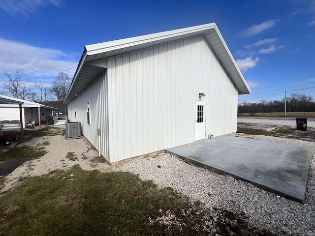 view of property exterior featuring central AC unit and a patio