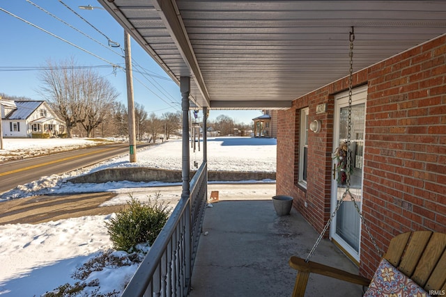 snow covered patio with covered porch