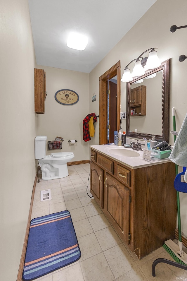 bathroom featuring toilet, vanity, and tile patterned floors