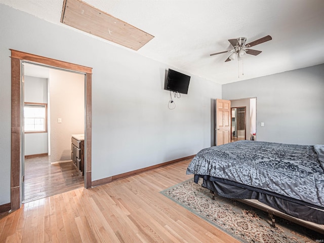 bedroom with ceiling fan, ensuite bathroom, and light hardwood / wood-style floors